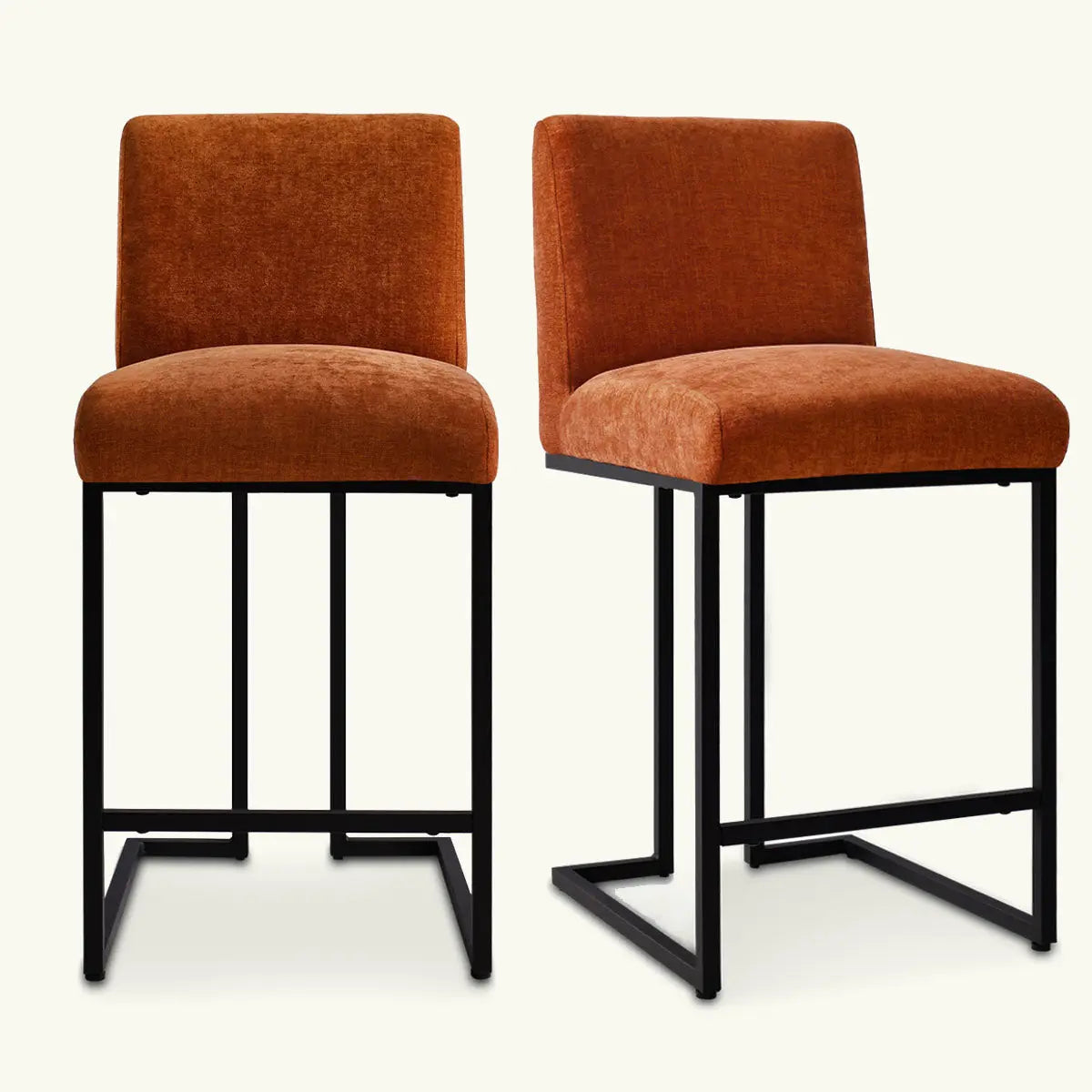 Two Mason Modern metal frame upholstered counter stools, orange fabric, black metal legs, room setting.