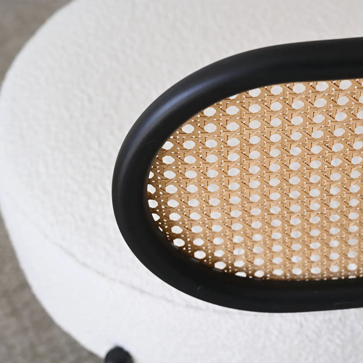 Marse Boucle Barrel Accent Chair with Rattan Back detail, beige boucle upholstery, close-up view.