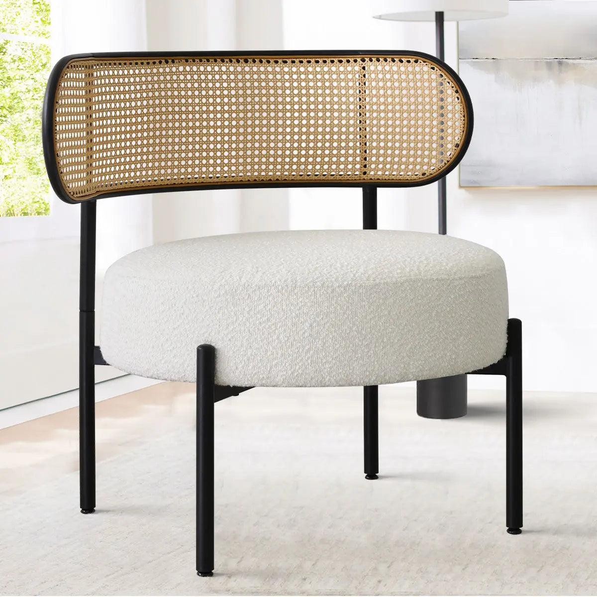 Marse Boucle Upholstered Barrel Chair, rattan back, in modern white room with light flooring.