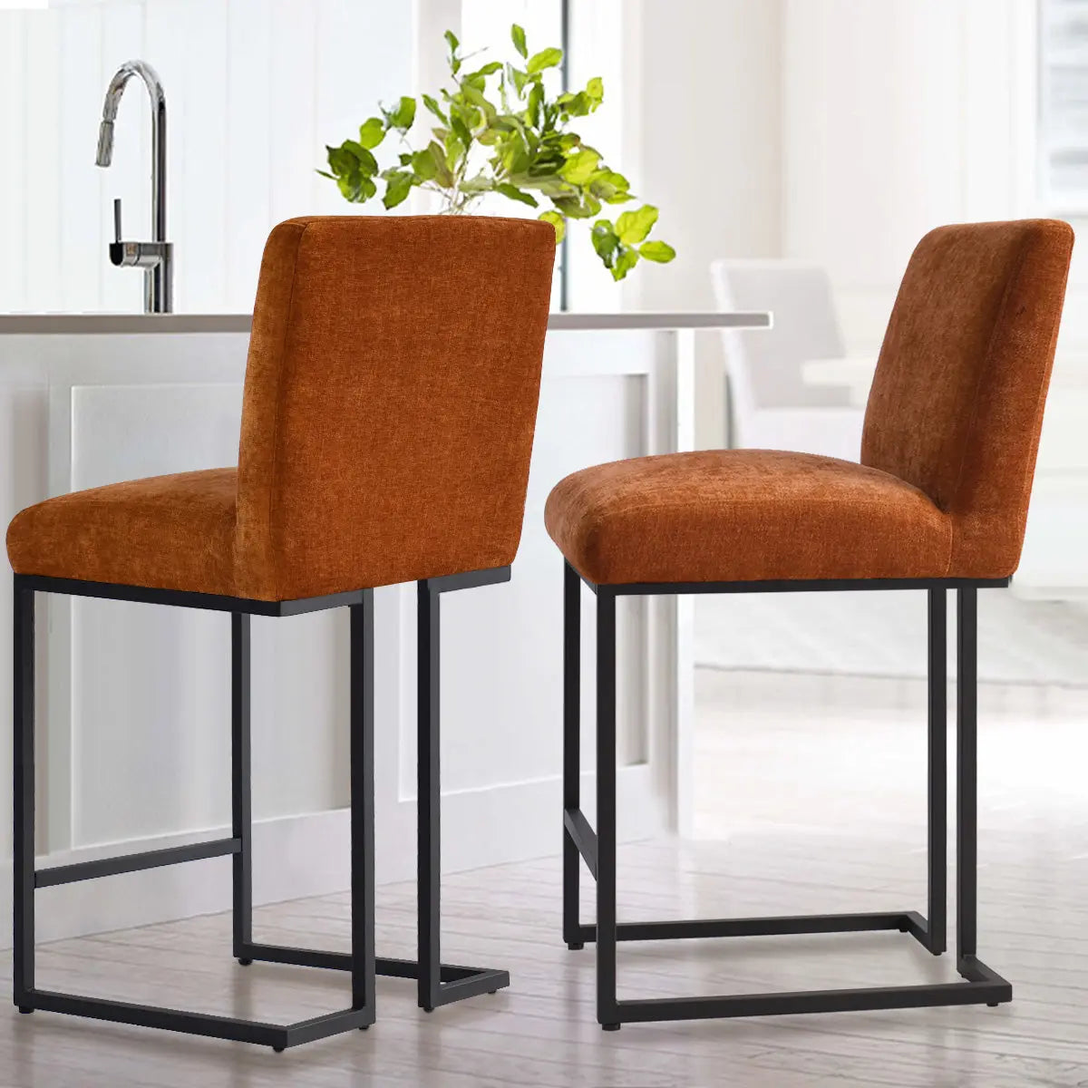 Two Mason Modern Metal Frame Upholstered Counter Stools in kitchen with white cabinets and wood flooring.