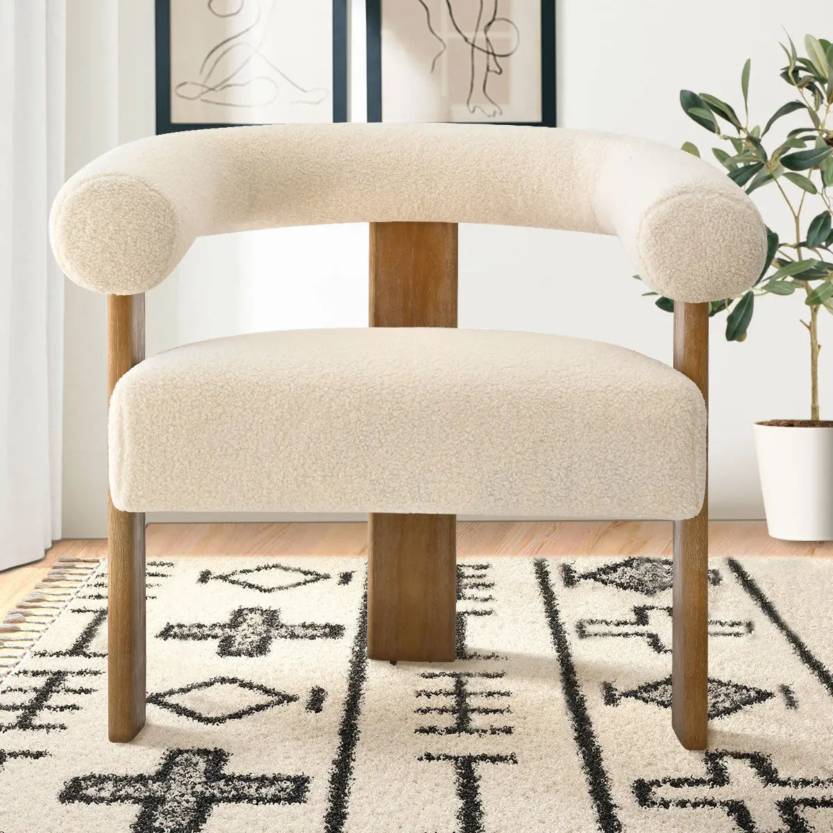 Maye Beige Boucle Upholstered Chair with Arms, artistic wall art, textured rug, wooden flooring.