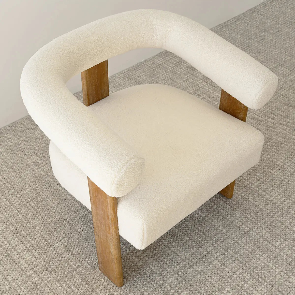 Maye Beige Boucle Chair, wooden legs, textured carpet flooring in living room. Dimensions available.