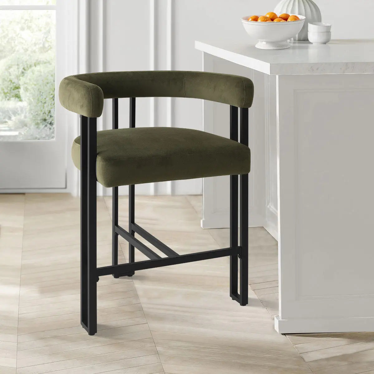 Mia Velvet Accent Counter Stool in kitchen with marble countertop, herringbone flooring, white cabinetry.