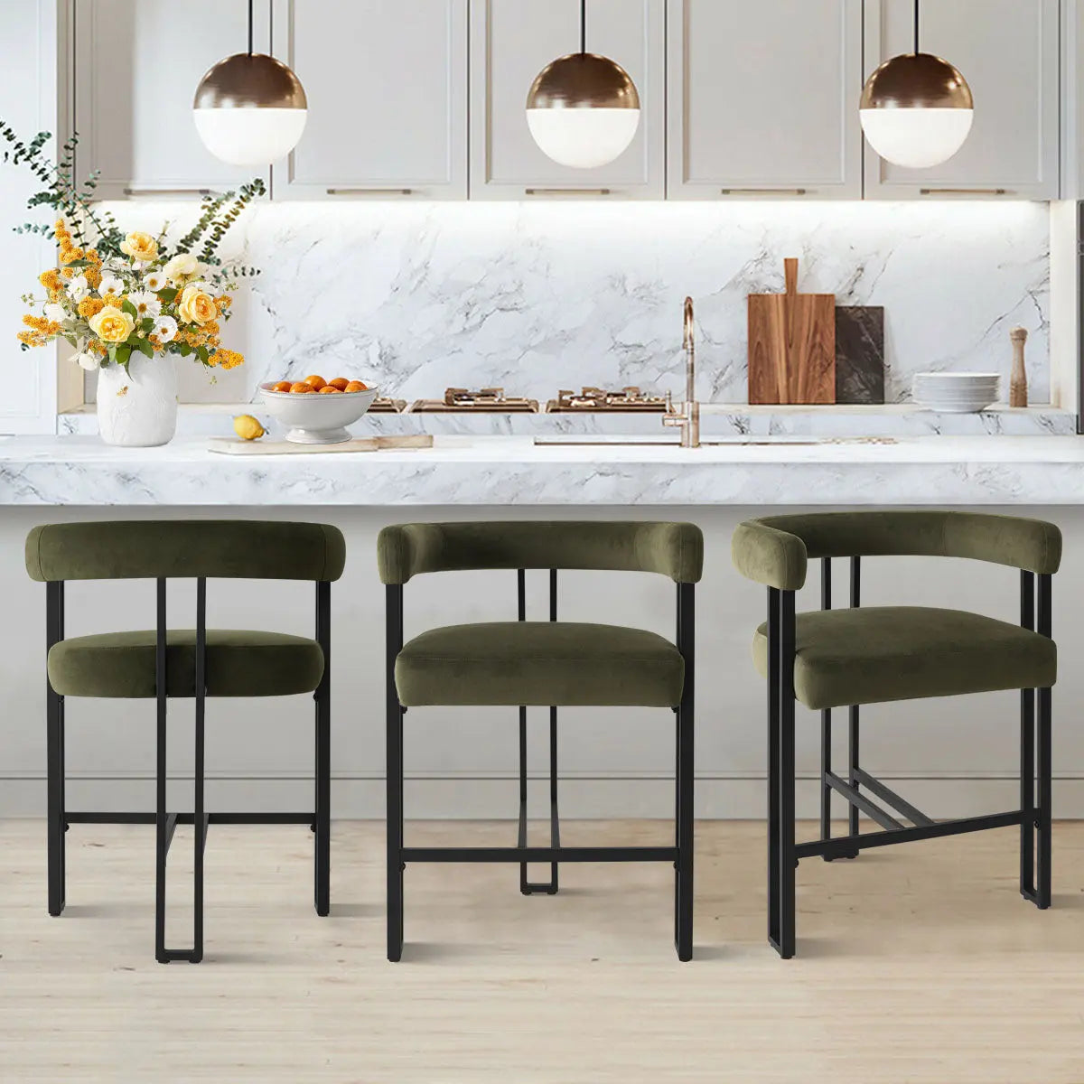 Meridian Furniture Mia velvet counter stools in kitchen with marble counter, white cabinets, wood flooring.