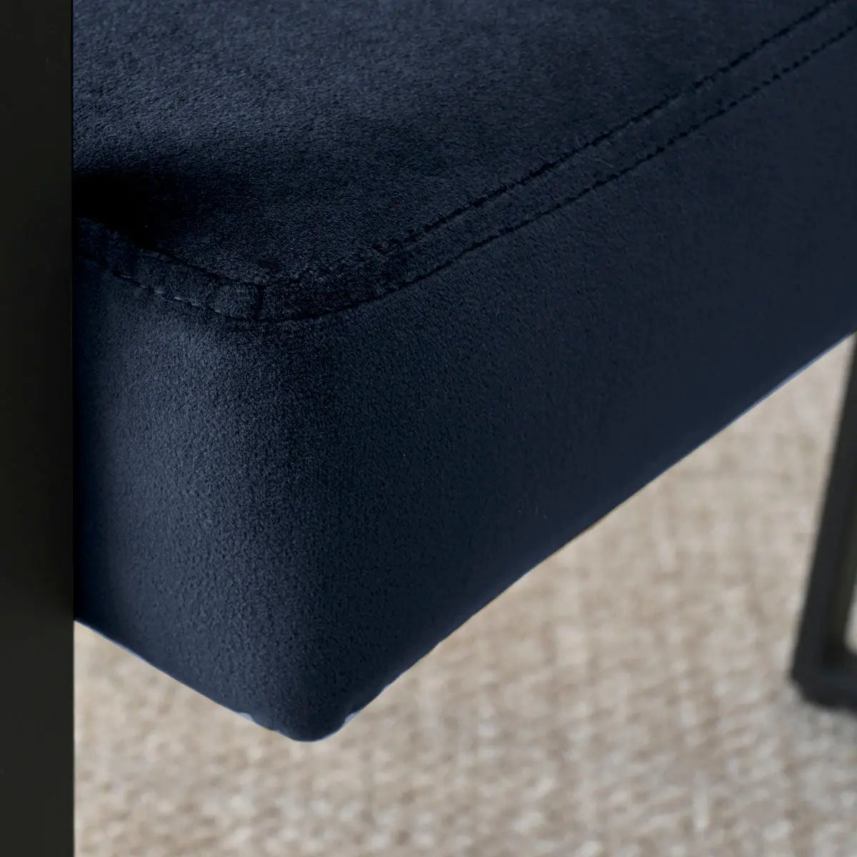 Close-up of Mia Velvet Accent Dining Chair seat on textured beige carpet flooring.