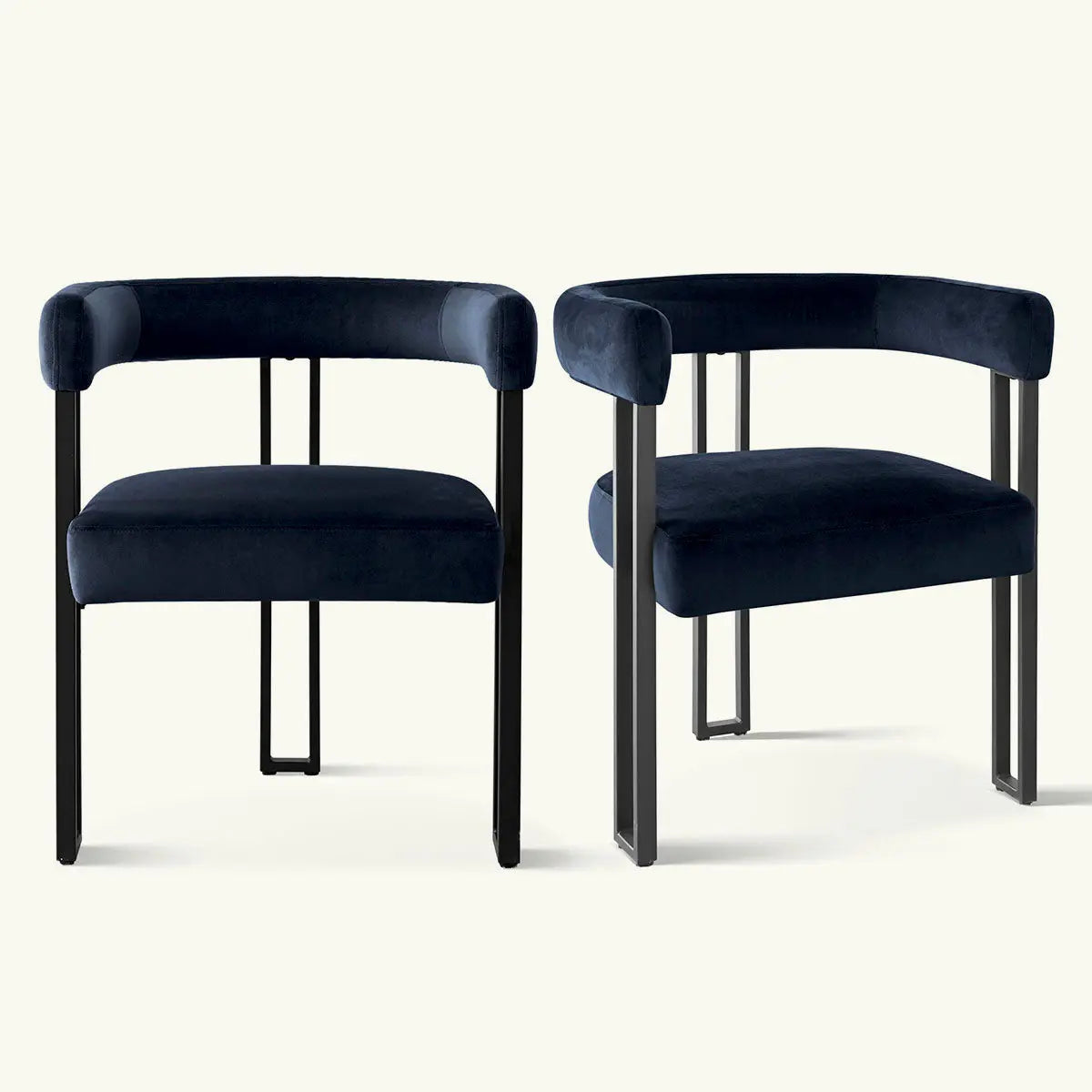 Pair of Mia Velvet Accent Dining Chairs with black legs on light background. Elegant dining seating.