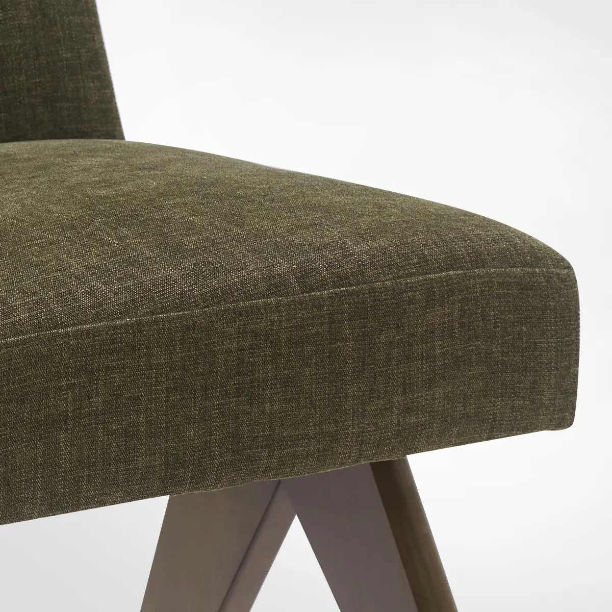 Close-up of Morgan Mid Century Modern Upholstered Dining Chair in green fabric, wooden legs visible.