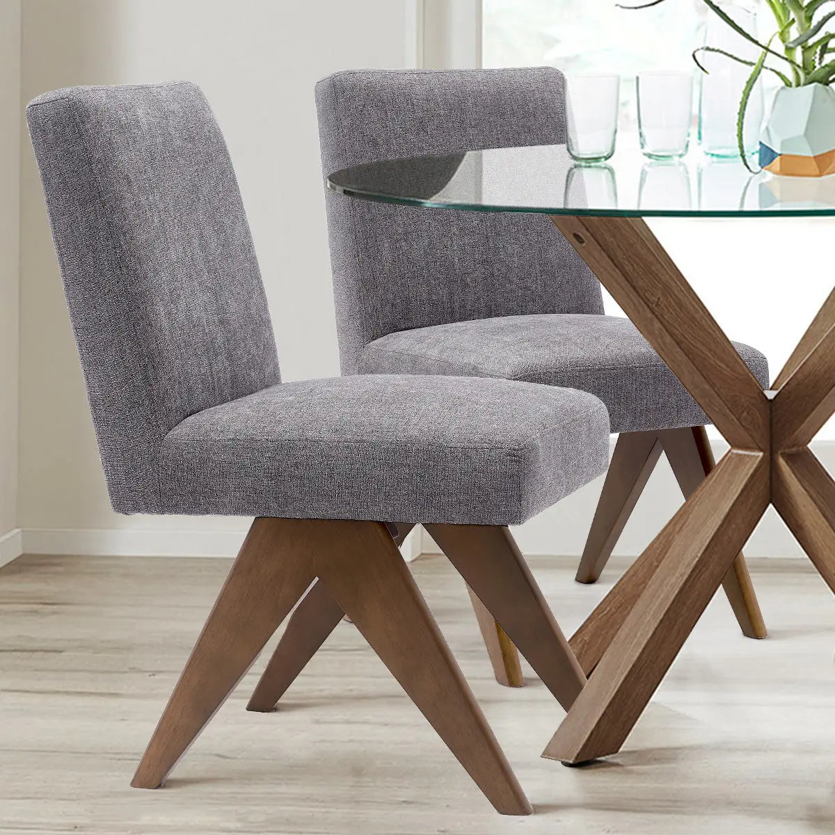 Morgan Mid Century Modern Upholstered Dining Chair with wood legs, glass table, and light wood flooring.