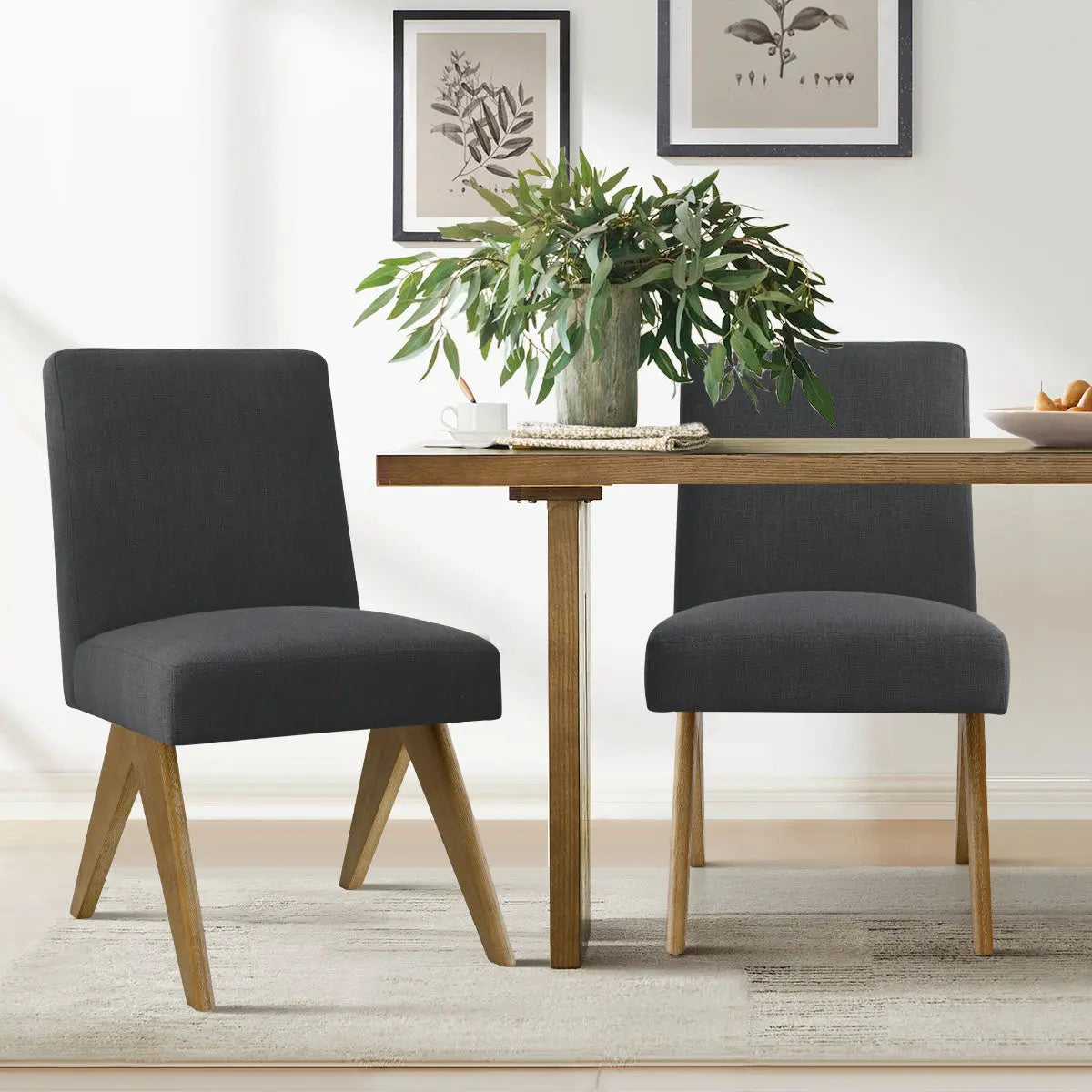 Morgan Mid-Century Boucle Upholstered Dining Chair in modern dining room with wooden table, light rug.