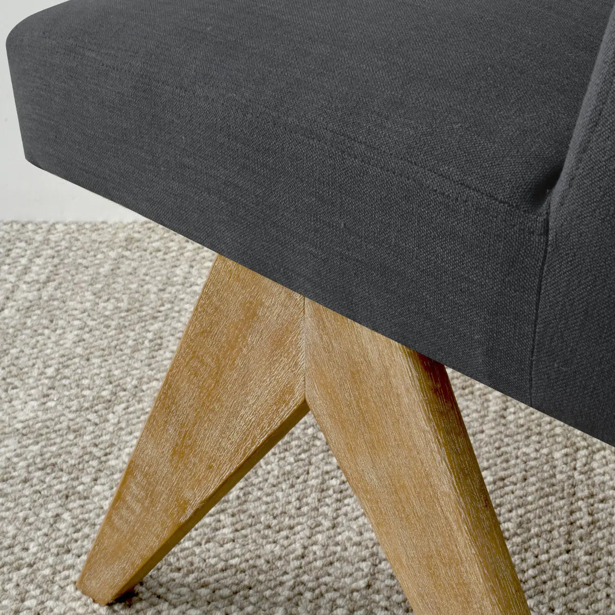 Morgan Mid-Century Boucle Upholstered Dining Chair on textured gray carpet, featuring wooden legs.