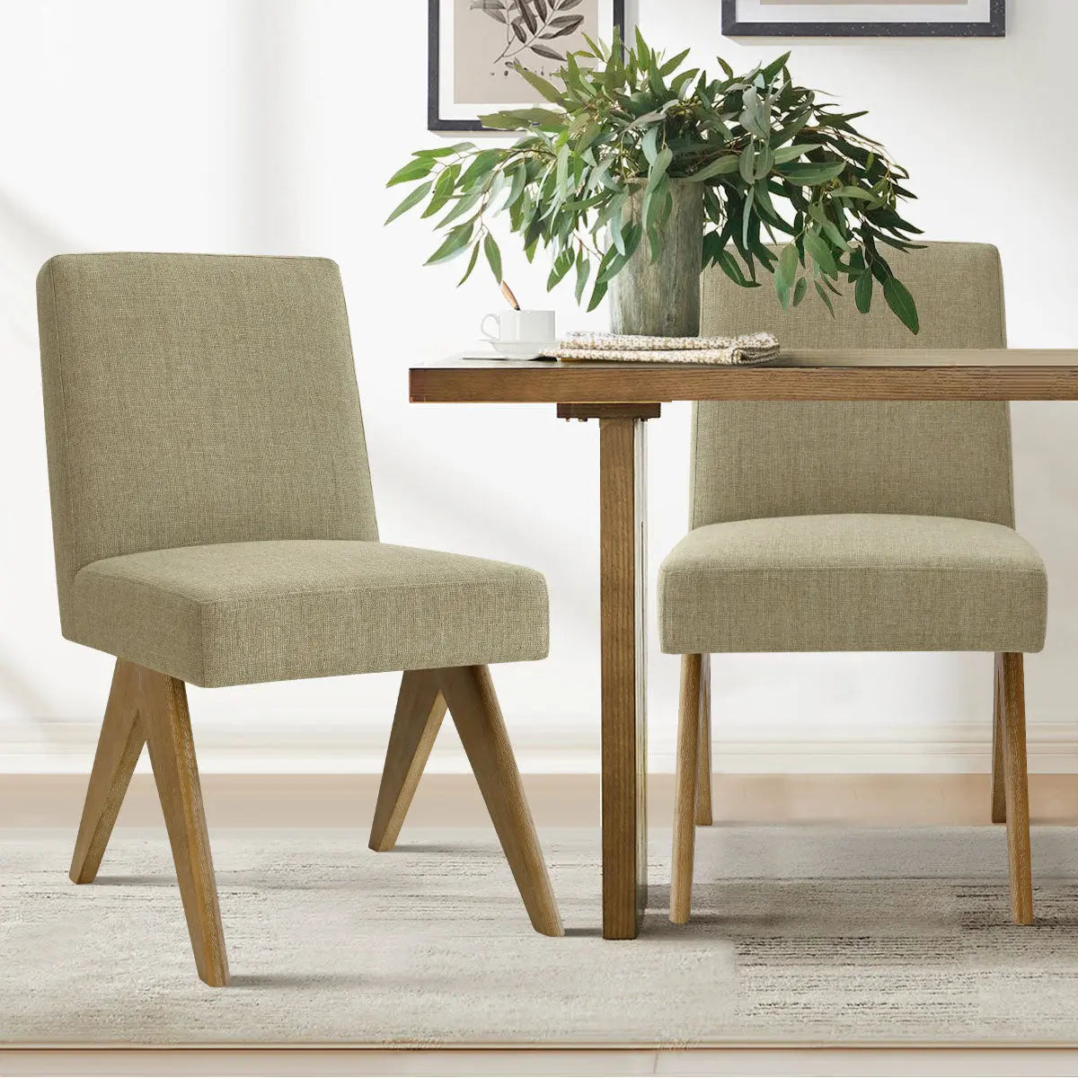 Morgan Mid-Century Boucle Dining Chairs beside wooden table on rug in a modern dining room.