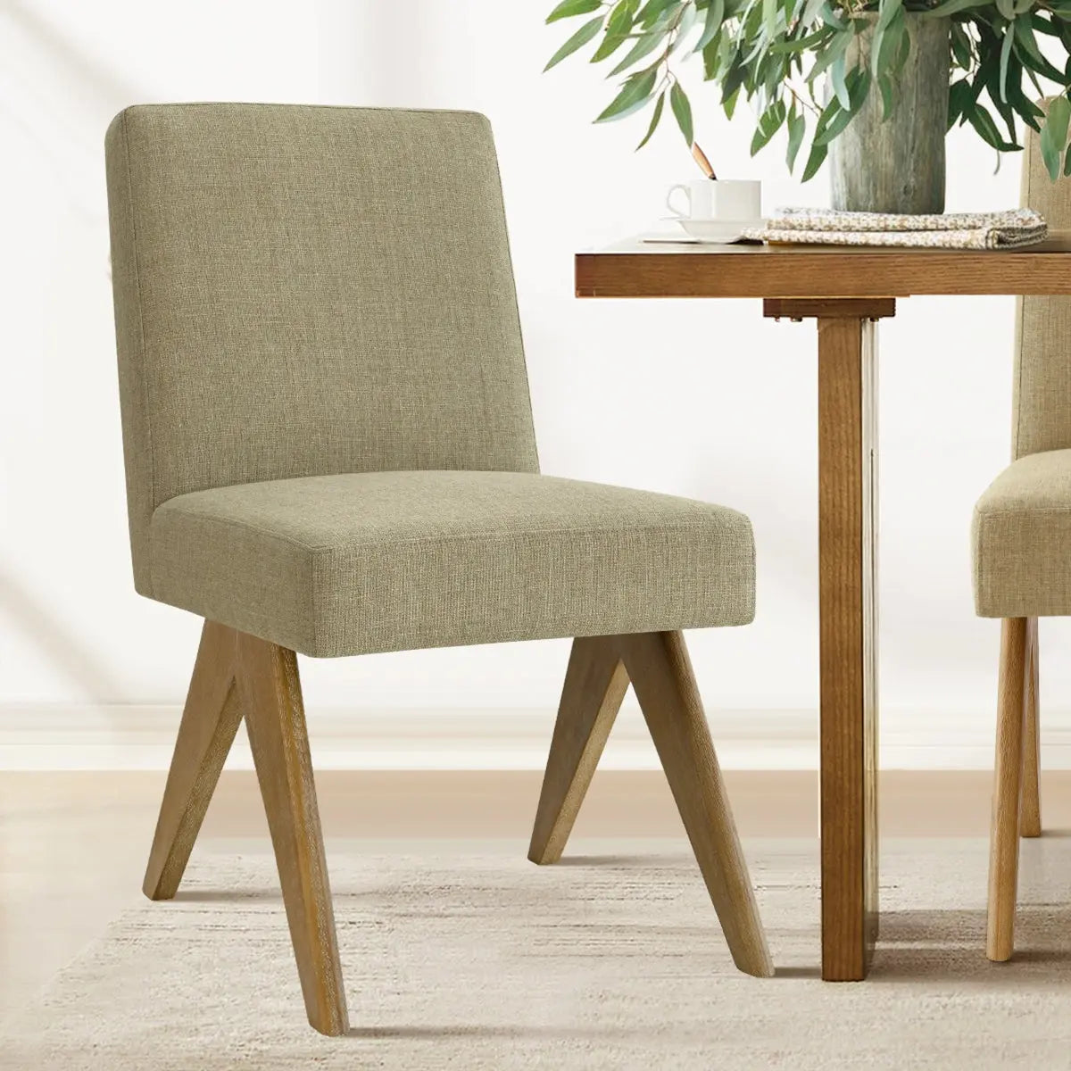 Morgan Mid-Century Boucle Upholstered Dining Chair in room with wooden table and neutral rug.