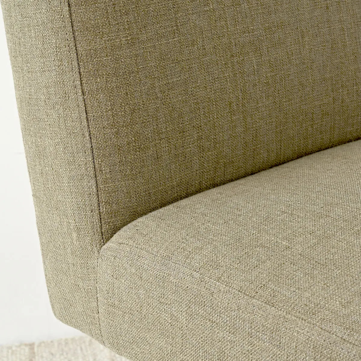 Close-up of Morgan Mid-Century upholstered chair fabric in boucle; soft beige tones; textured design.