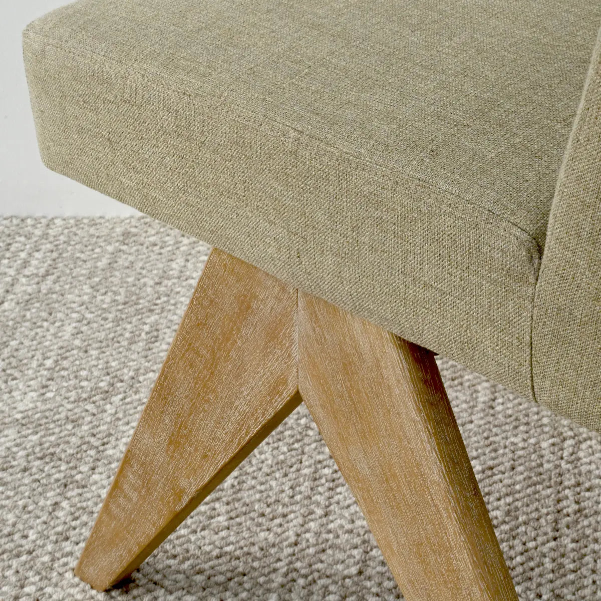 Morgan Mid-Century Boucle Dining Chair with wooden legs, textured carpet flooring, light-toned upholstery.