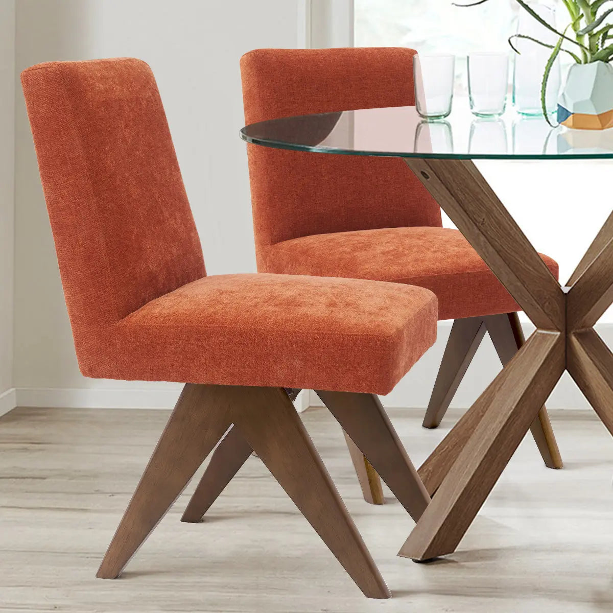 Orange Morgan Mid Century Modern Upholstered Dining Chair, glass table, light wood flooring, white walls.