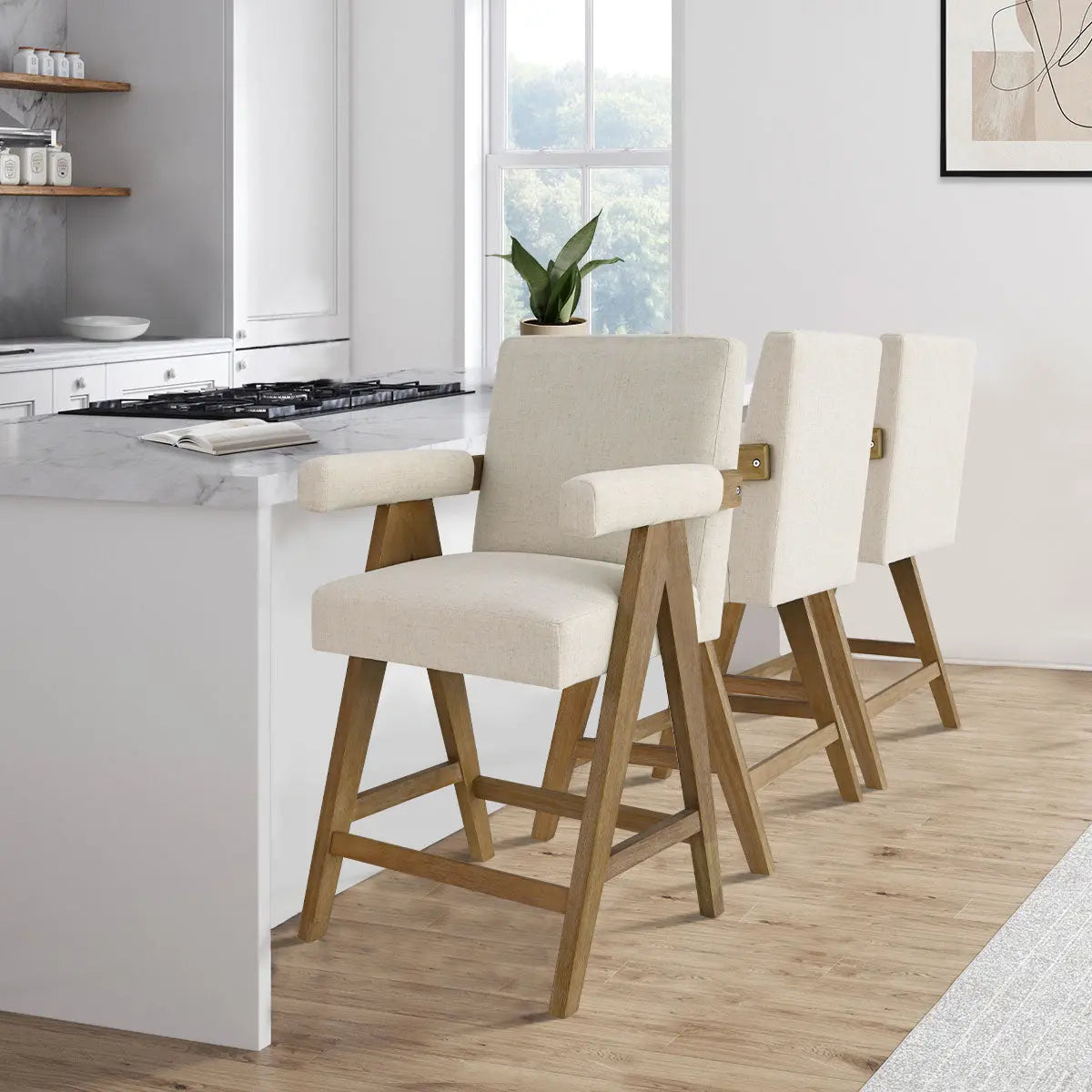 Morgan Mid Century modern upholstered counter stools in kitchen, wood flooring, white walls, marble countertop.