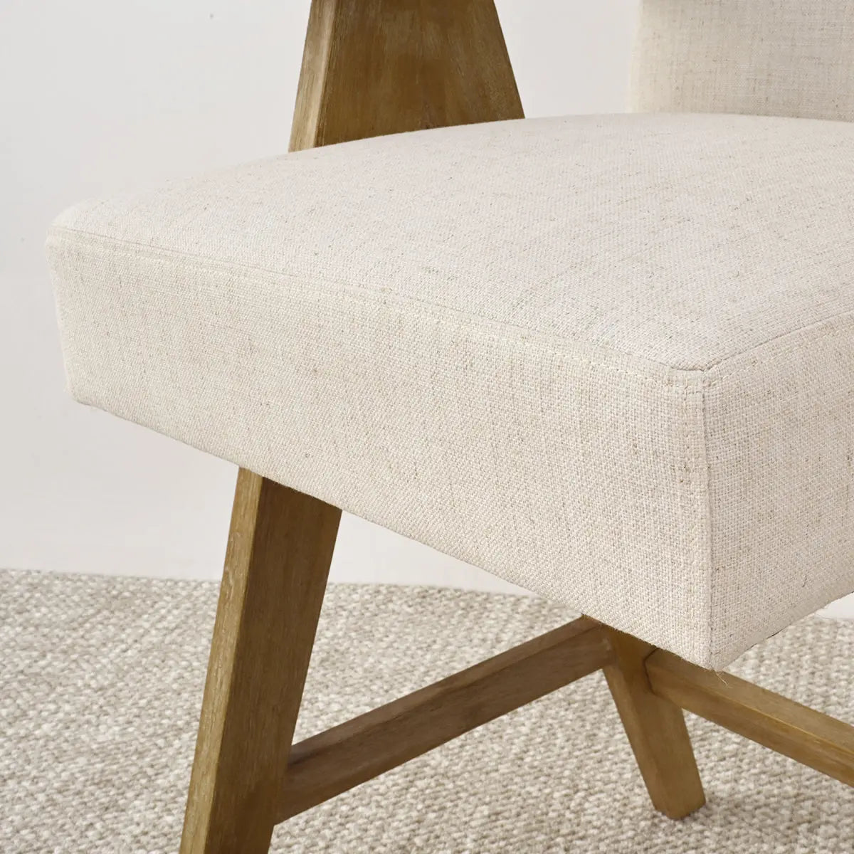 Morgan Mid Century Upholstered Counter Stool with wooden legs on textured carpet.