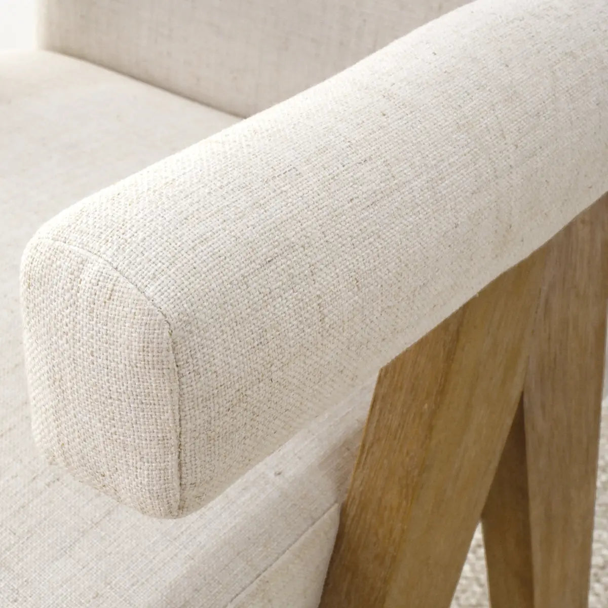 Morgan Mid Century Upholstered Counter Stool arm detail with wooden legs in neutral setting.