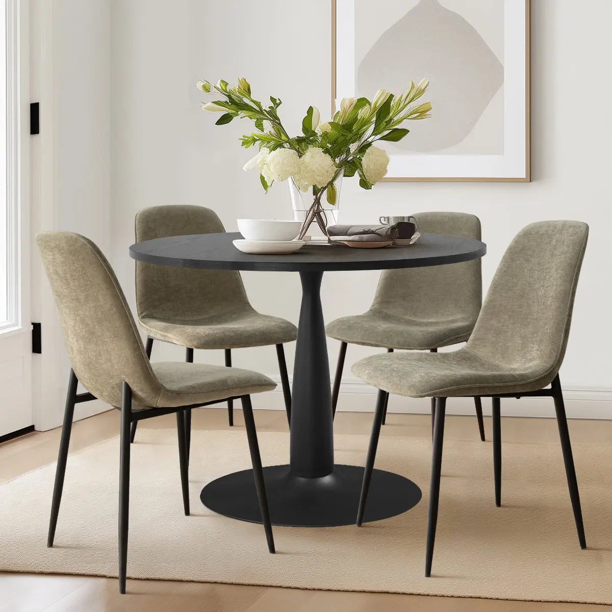 Haven & Oslo Black Round Dining Table Set, beige chairs, modern dining room, light wood flooring.