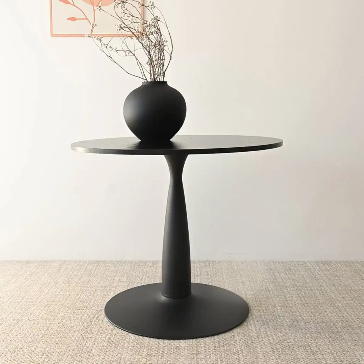 Haven & Oslo Black Round Dining Table Set on beige carpet in minimalist room with wall art.