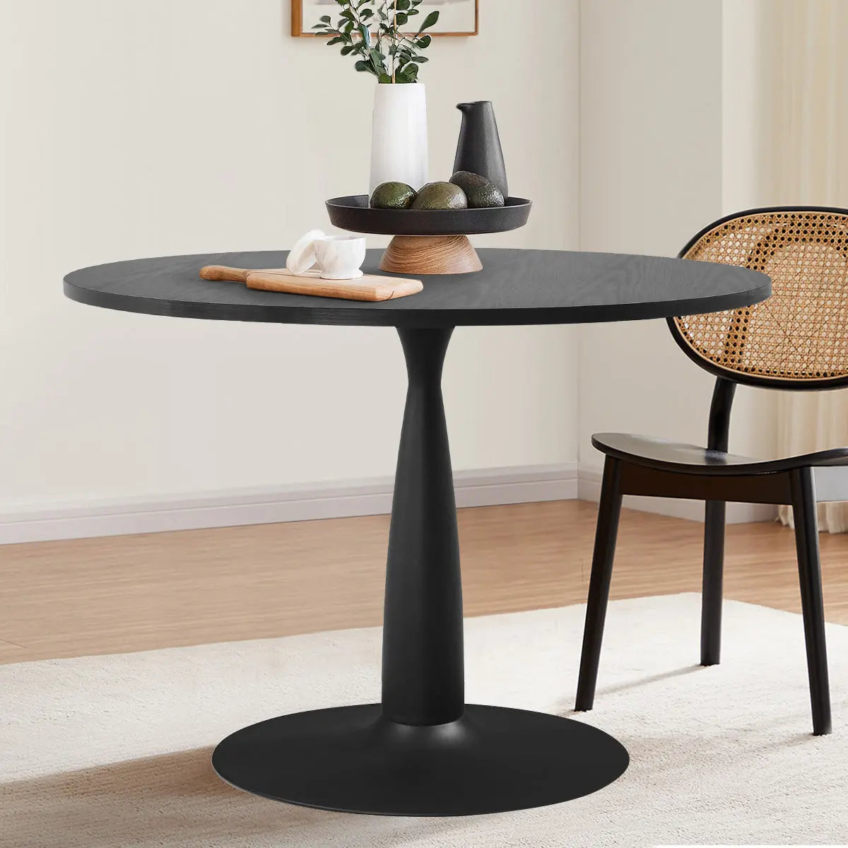 Haven Modern Black Round Dining Table in dining space with neutral walls and wooden flooring.