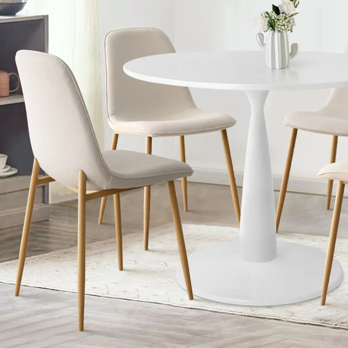 Haven & Oslo dining set with white table, beige chairs, in living room with light wood flooring.