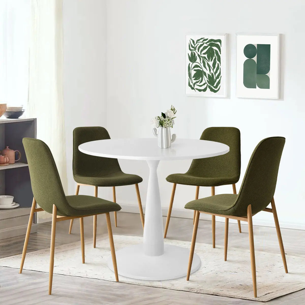 Haven & Oslo dining table set with white round table, olive chairs, wooden legs, light walls.