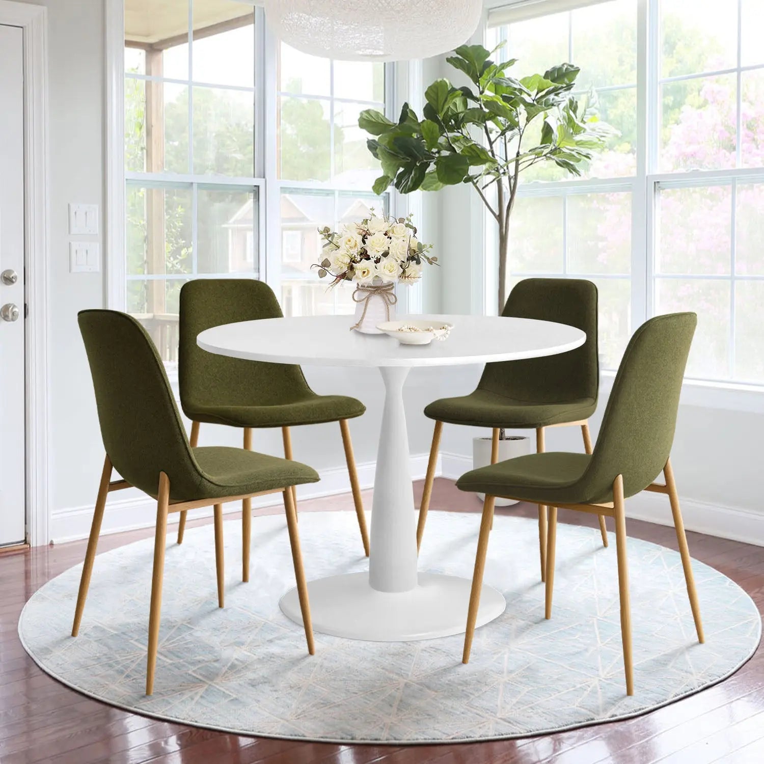 Haven & Oslo dining set with green chairs, white table, wooden floor, light walls in dining room.