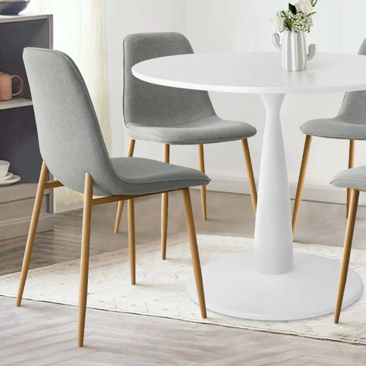 Haven & Oslo dining table set with grey chairs, light wood legs, in modern dining room.