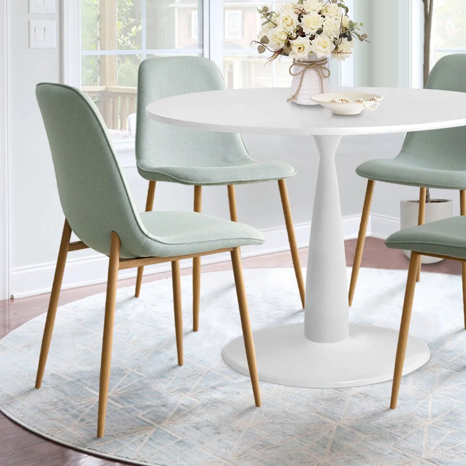 Haven & Oslo dining set with white table, light green chairs, hardwood flooring, room with windows.