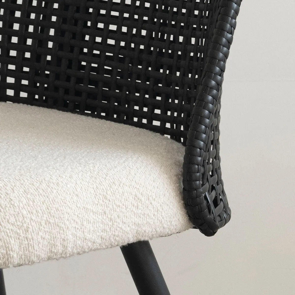 Nice Rattan Upholstered Dining Chair close-up, sleek design, woven texture, beige fabric seat upholstery.