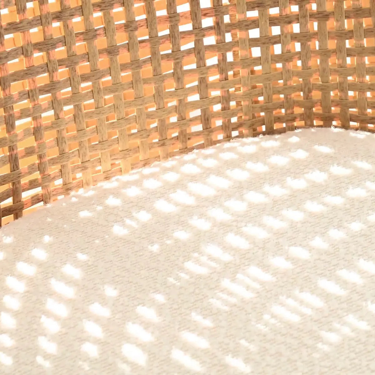 Close-up of Dwen & Nice rattan texture and beige fabric from dining table set.