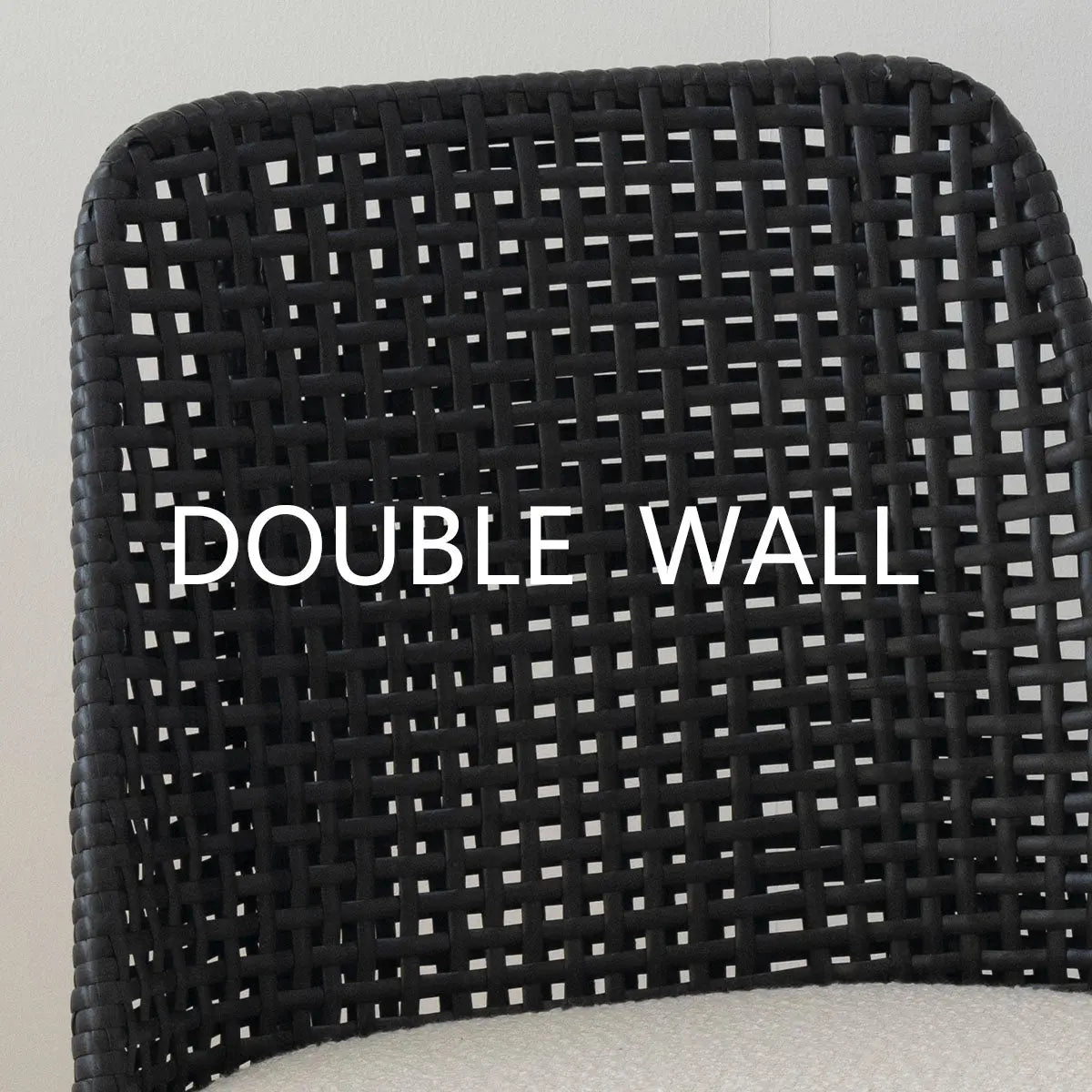 Double Wall black rattan upholstered counter stool detail showing intricate woven design.