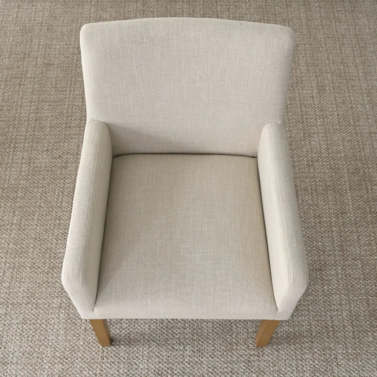 North Modern Boucle Upholstered Armchair on textured carpet, beige fabric, cozy seating.