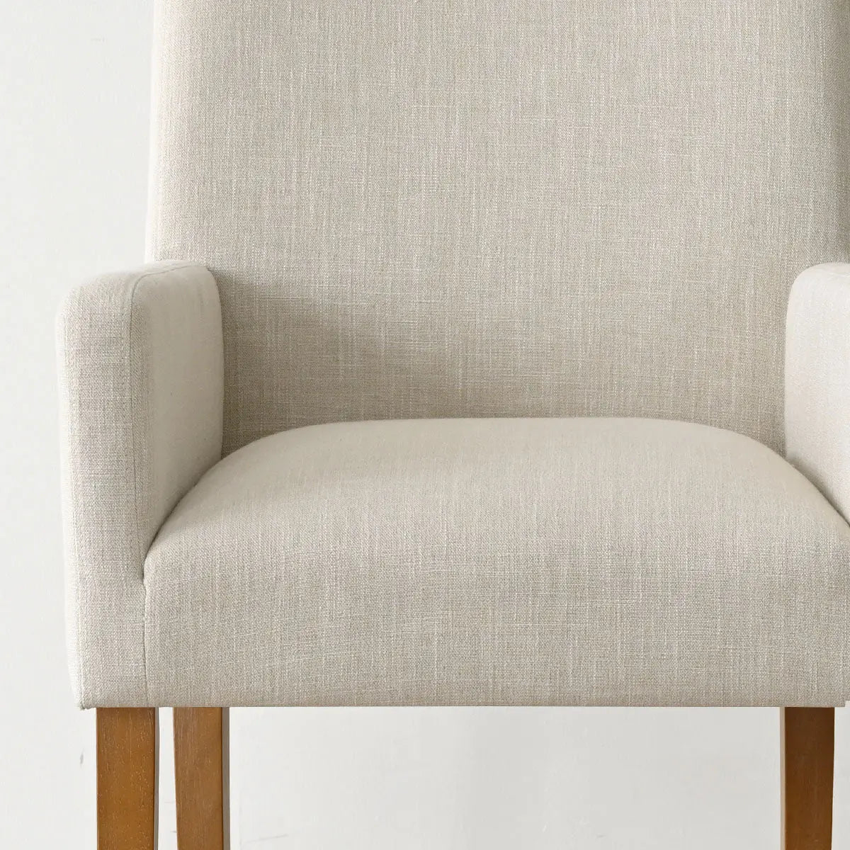 North Modern beige Boucle armchair with wooden legs, neutral wall, minimalist design, living room furniture.