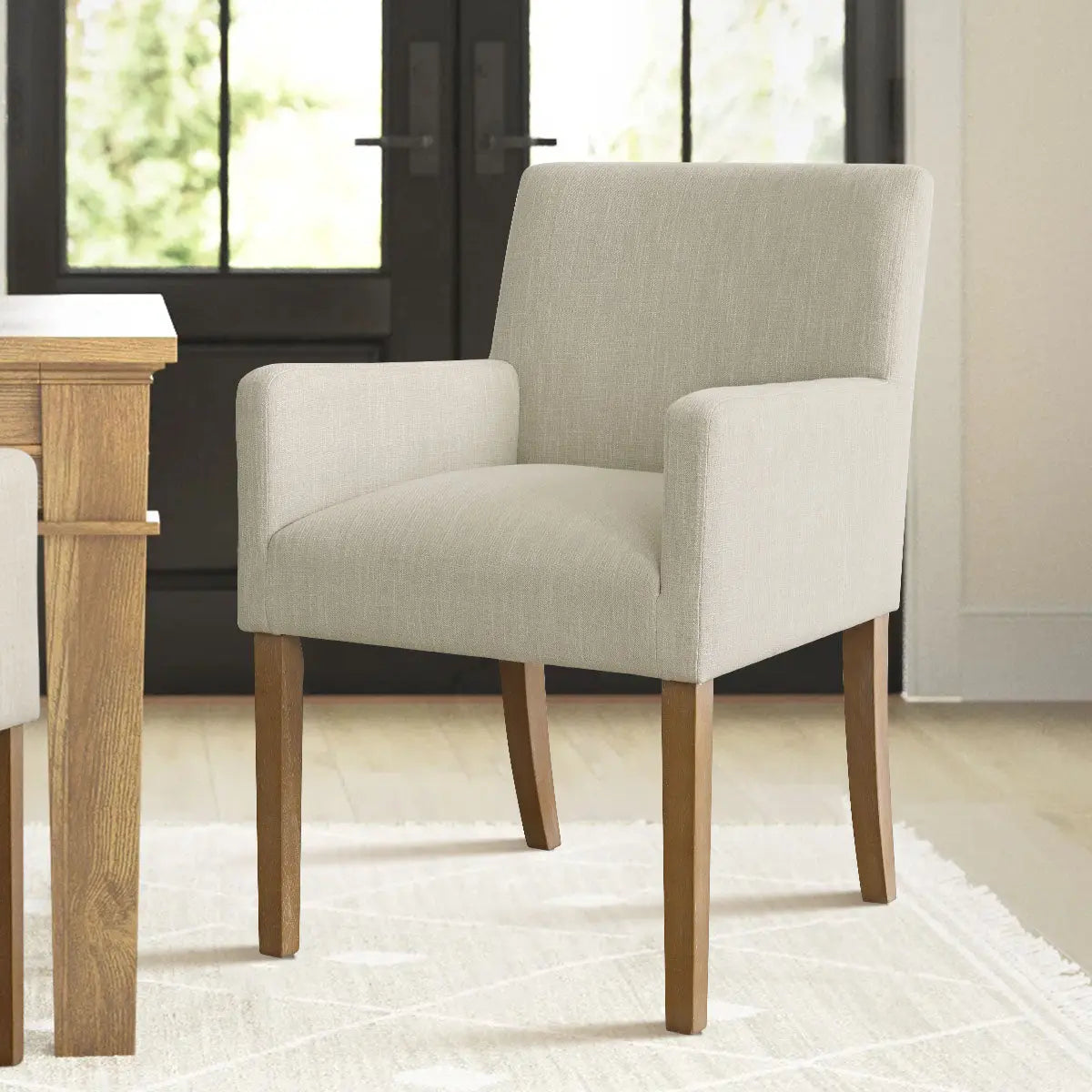 North Modern Boucle Upholstered Armchair in a bright room with wooden table, rug, and light flooring.