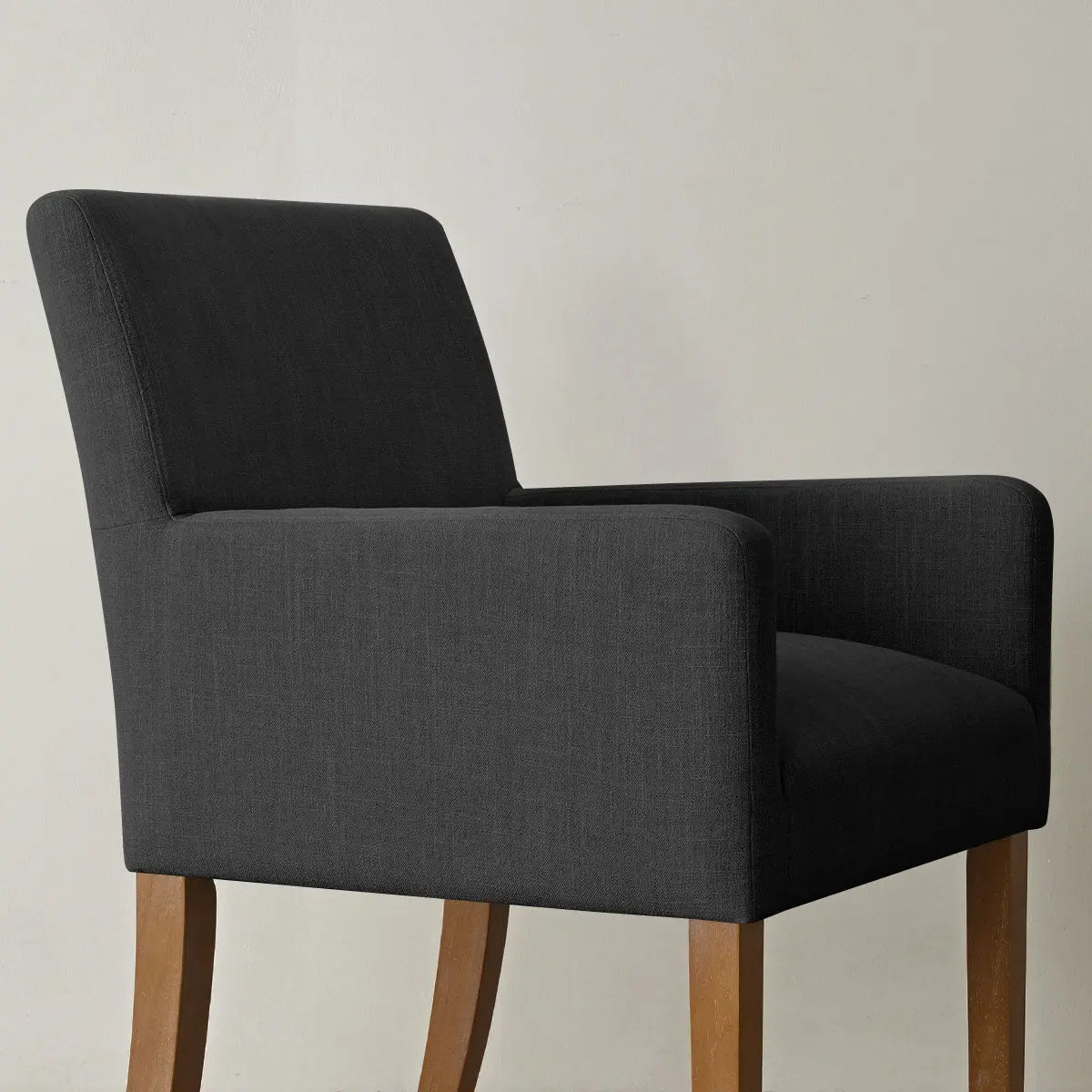 North Modern Boucle Upholstered Armchair in dark fabric with wooden legs, minimalist design accentuating style.