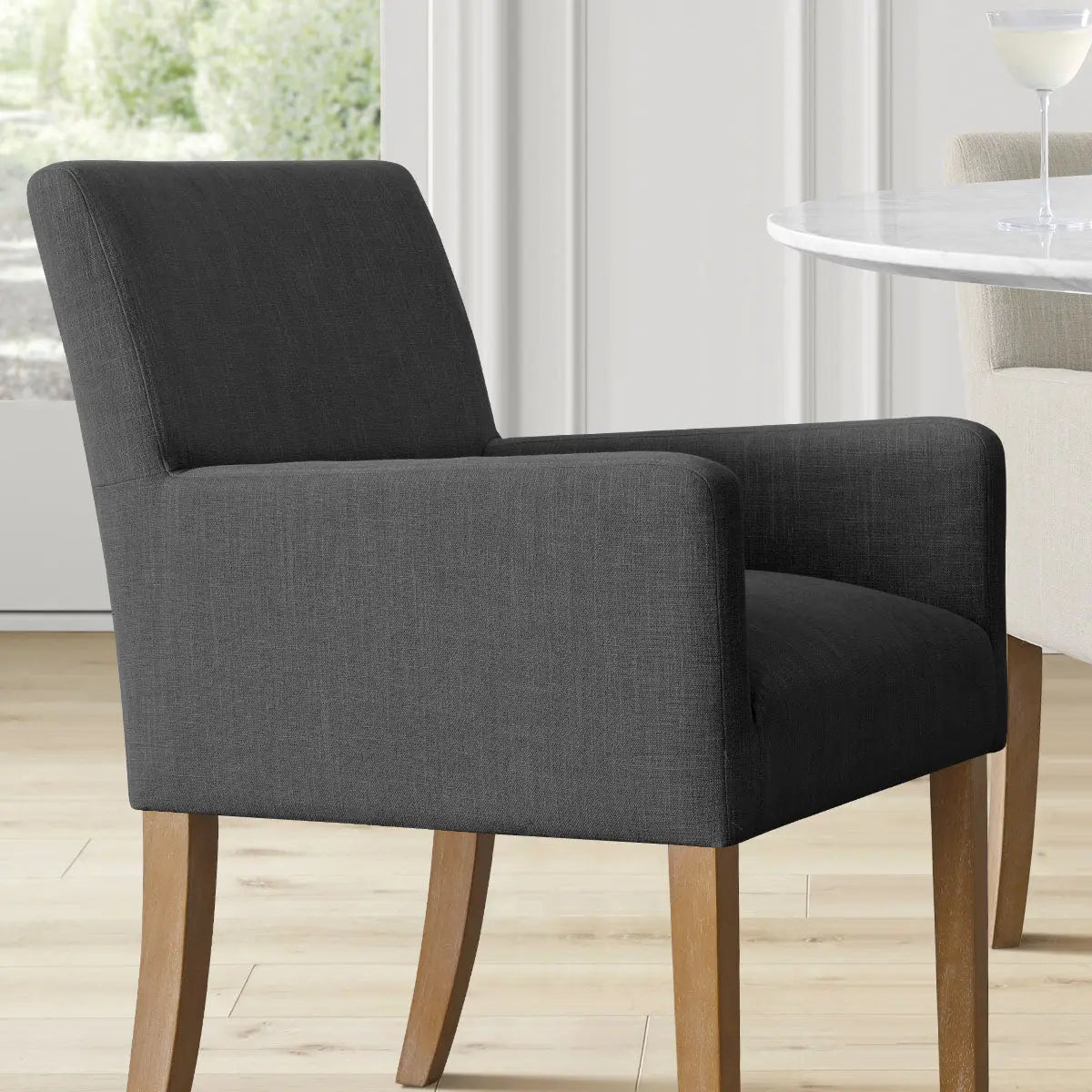 North Modern Boucle Upholstered Armchair in living room, light wood flooring, white table, gray fabric.