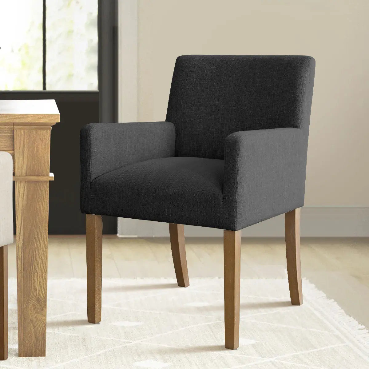 North Modern Boucle Upholstered Armchair in dining room, light wood flooring, neutral walls.