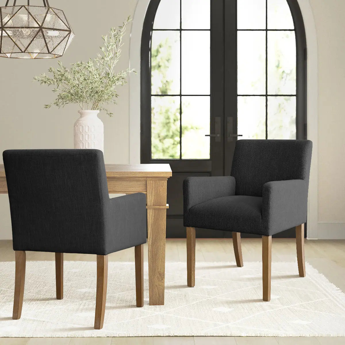 North Modern Boucle Armchair in stylish dining room with wooden table, light rug, and chic decor.