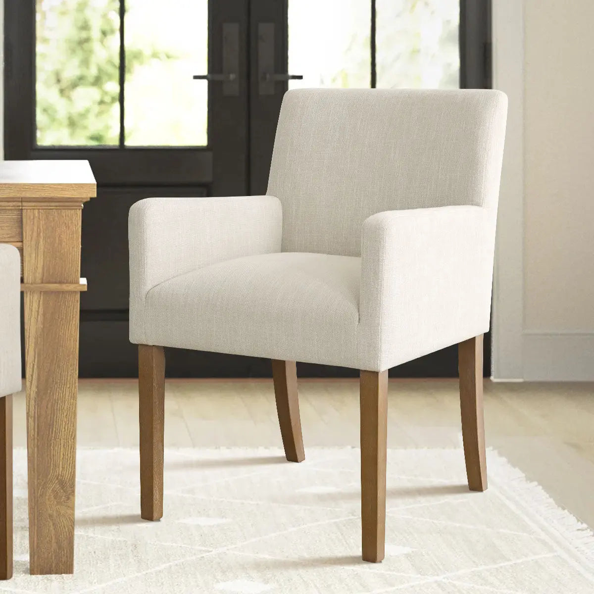 North Modern Boucle Armchair in dining room with wooden table, light rug, and oak flooring.