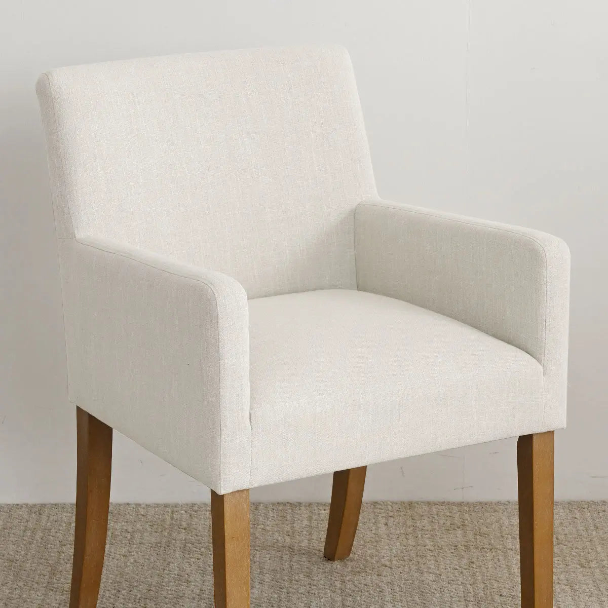 North Modern Boucle Upholstered Armchair on neutral carpet with light wall.