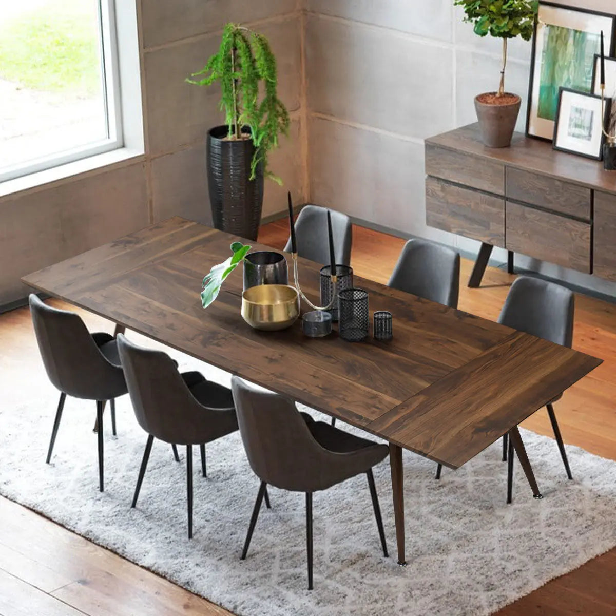 Odense 95" extendable dining table in modern room with wood flooring, gray chairs, and sideboard.