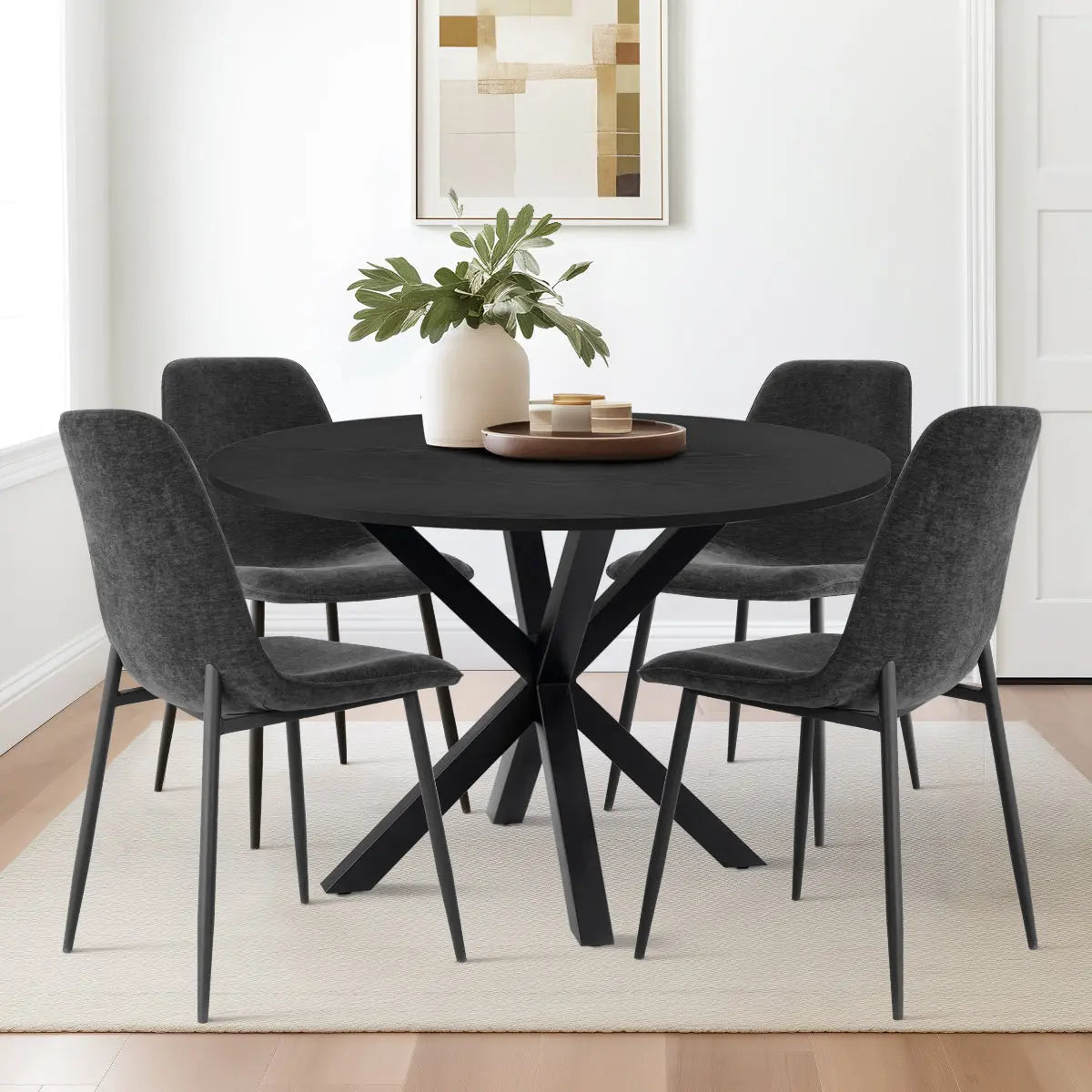 Stylish Oliver & Oslo dining table set with black chairs in a modern dining room setting.