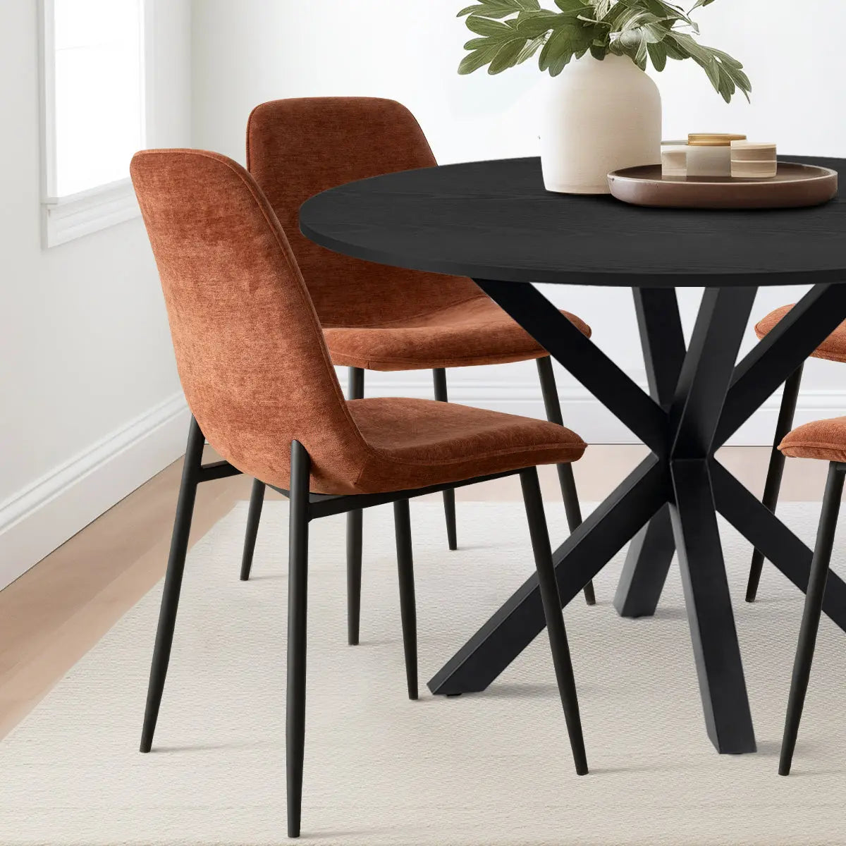 Oliver & Oslo Round Dining Table Set with brown chairs on light wood flooring in dining room.