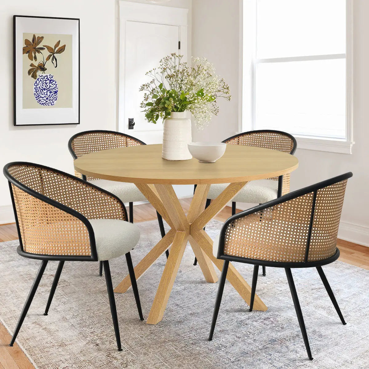 Oliver & Jules Rattan Dining Set, modern dining room, light wood floor, white walls, art print.