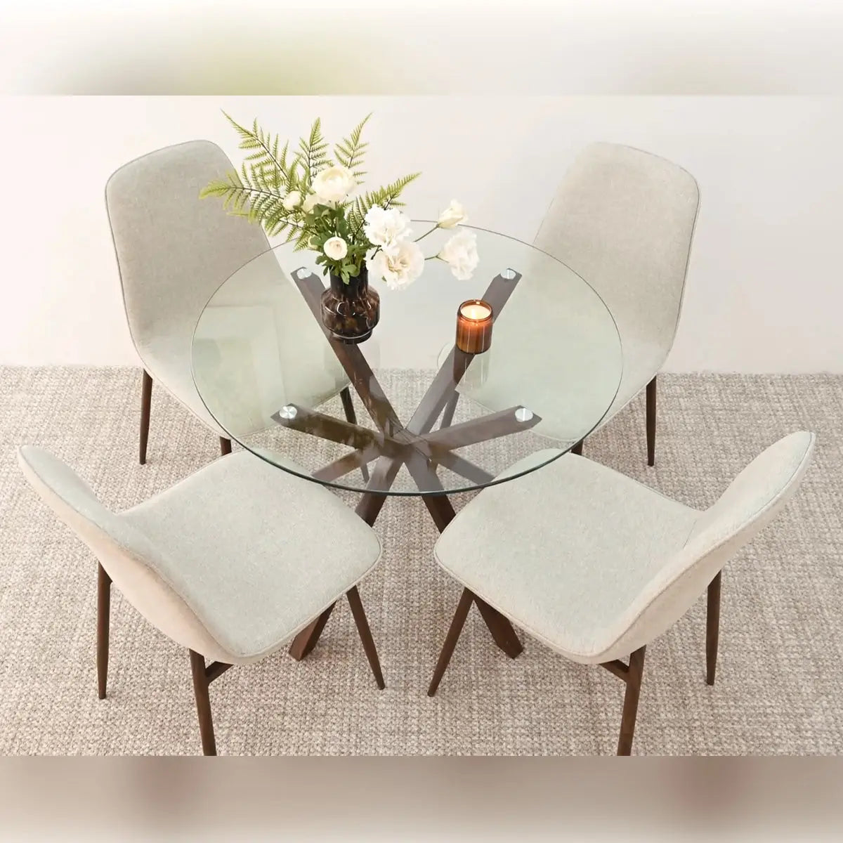 Oliver & Oslo round glass dining table set, beige fabric chairs, neutral rug, dining room style.