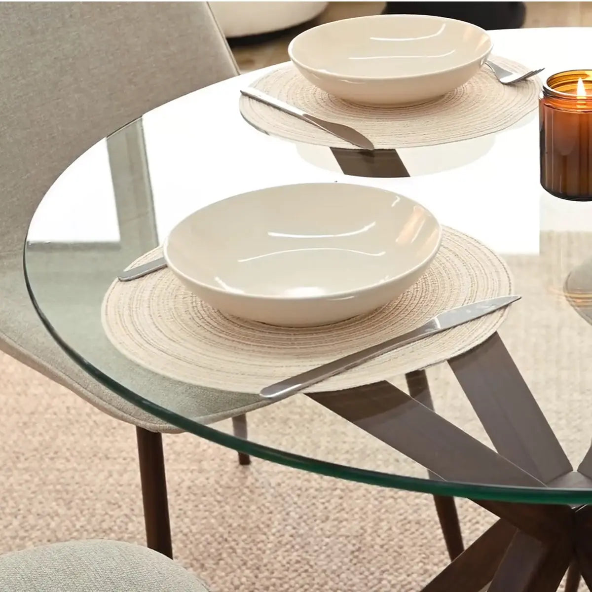 Oliver & Oslo glass dining table set with beige chairs on textured carpet in dining room.