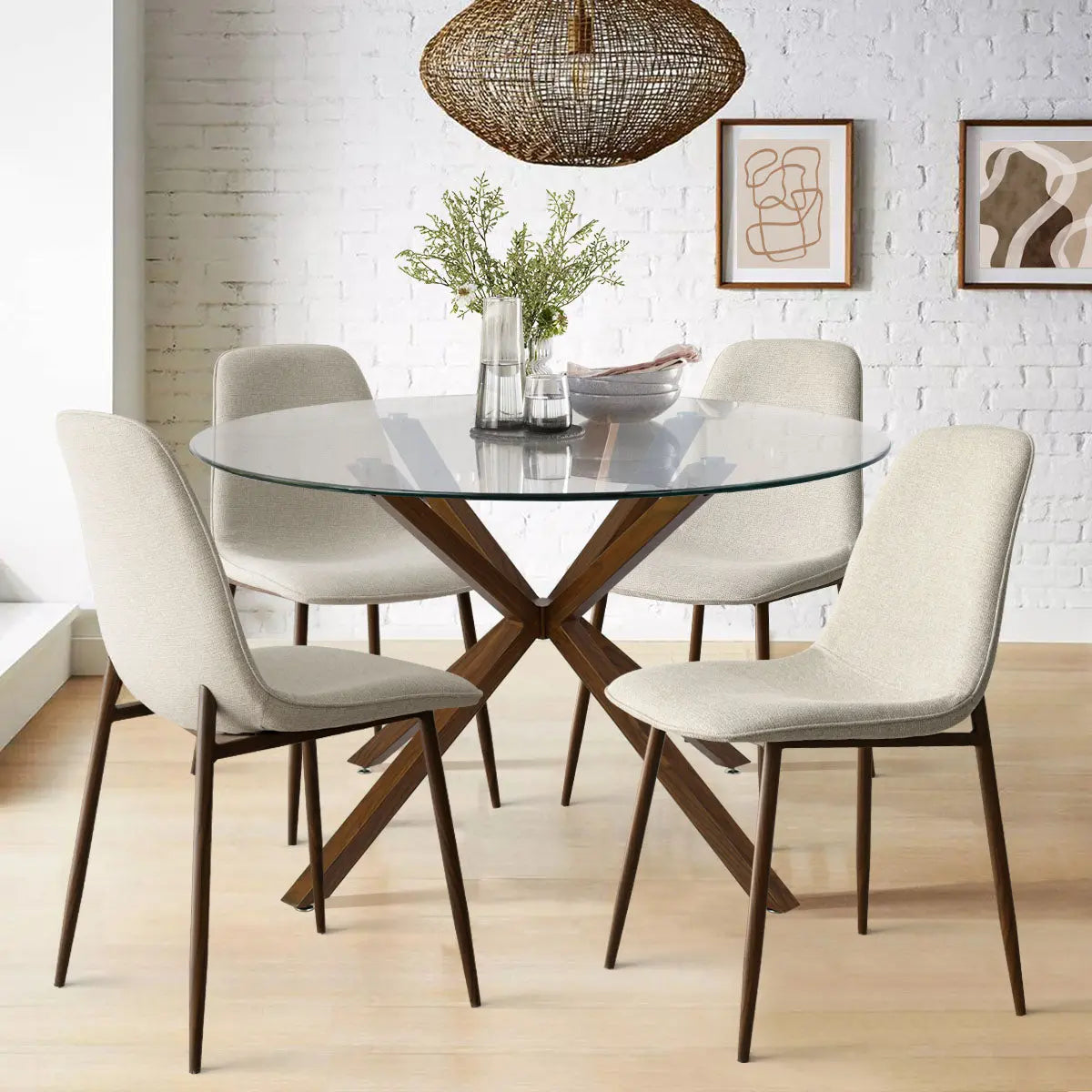 Oliver & Oslo glass round dining table set with beige chairs, white brick wall, wooden floor.