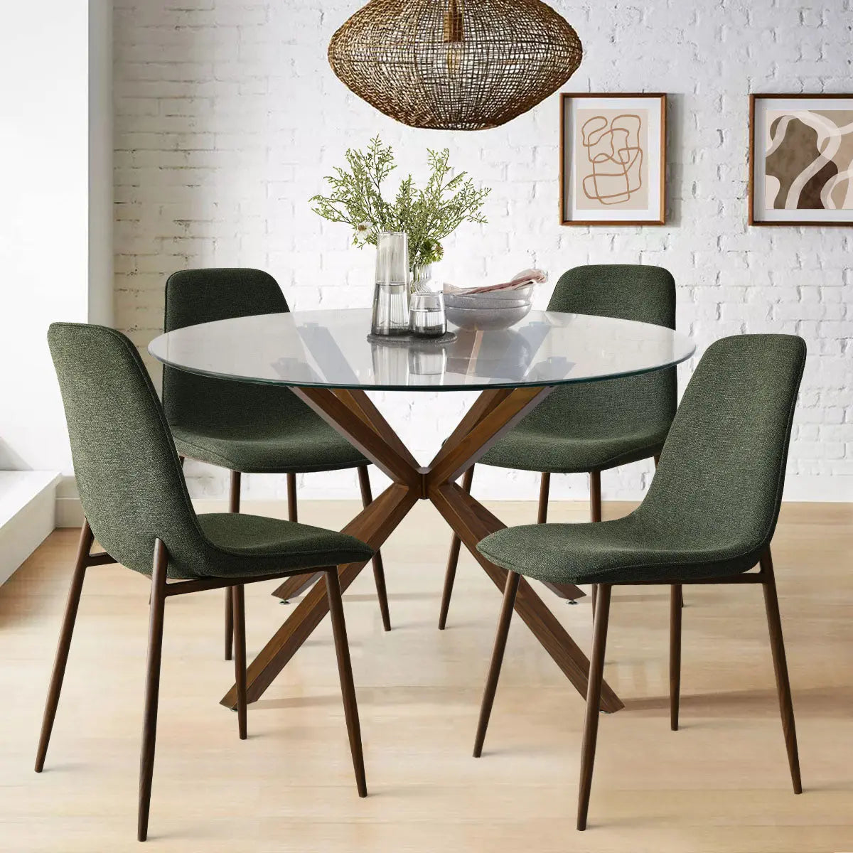 Oliver & Oslo Glass Round Dining Set with green chairs, wicker light, white brick wall, wood floor.